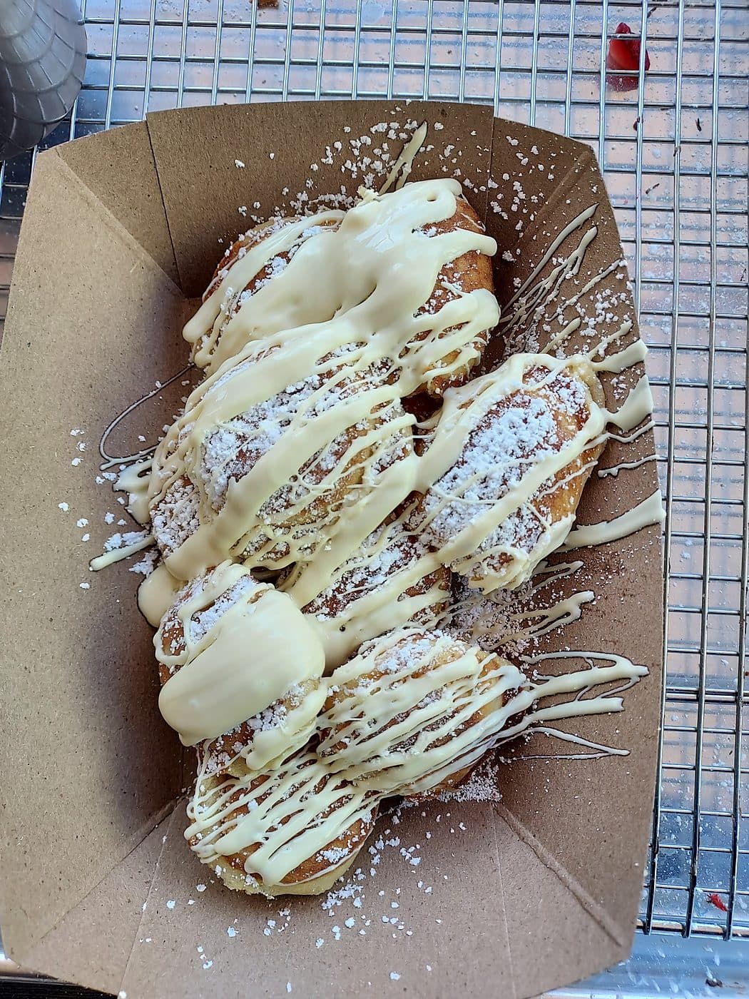 Dutch mini pancakes drizzled with white chocolate and powdered sugar at a wedding
