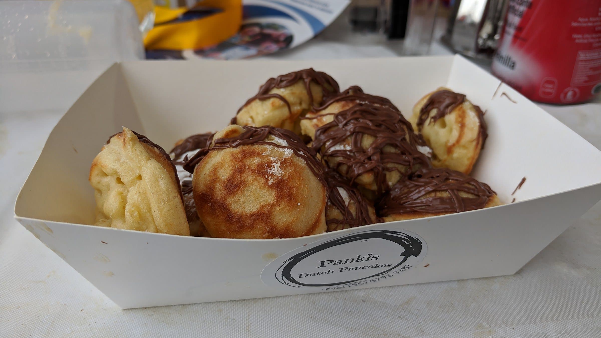 Dutch mini pancakes drizzled with white chocolate and powdered sugar at a Cincinnati wedding
