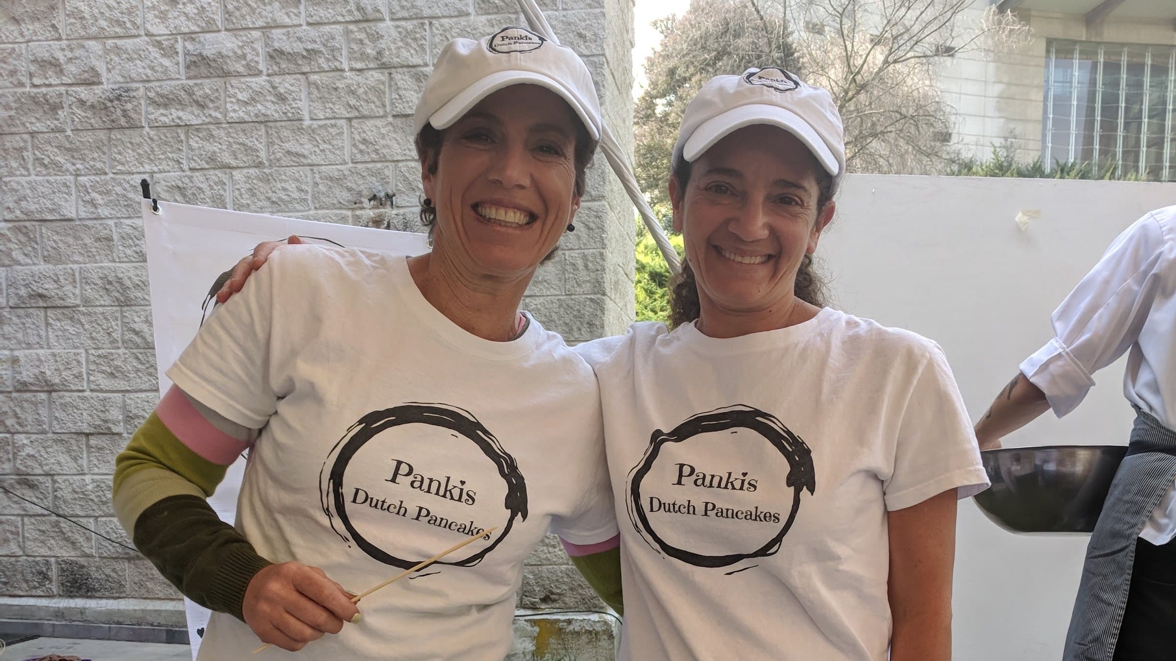 The Pankis Dutch Pancakes team beside the poffertjes griddle at a Cincinnati event