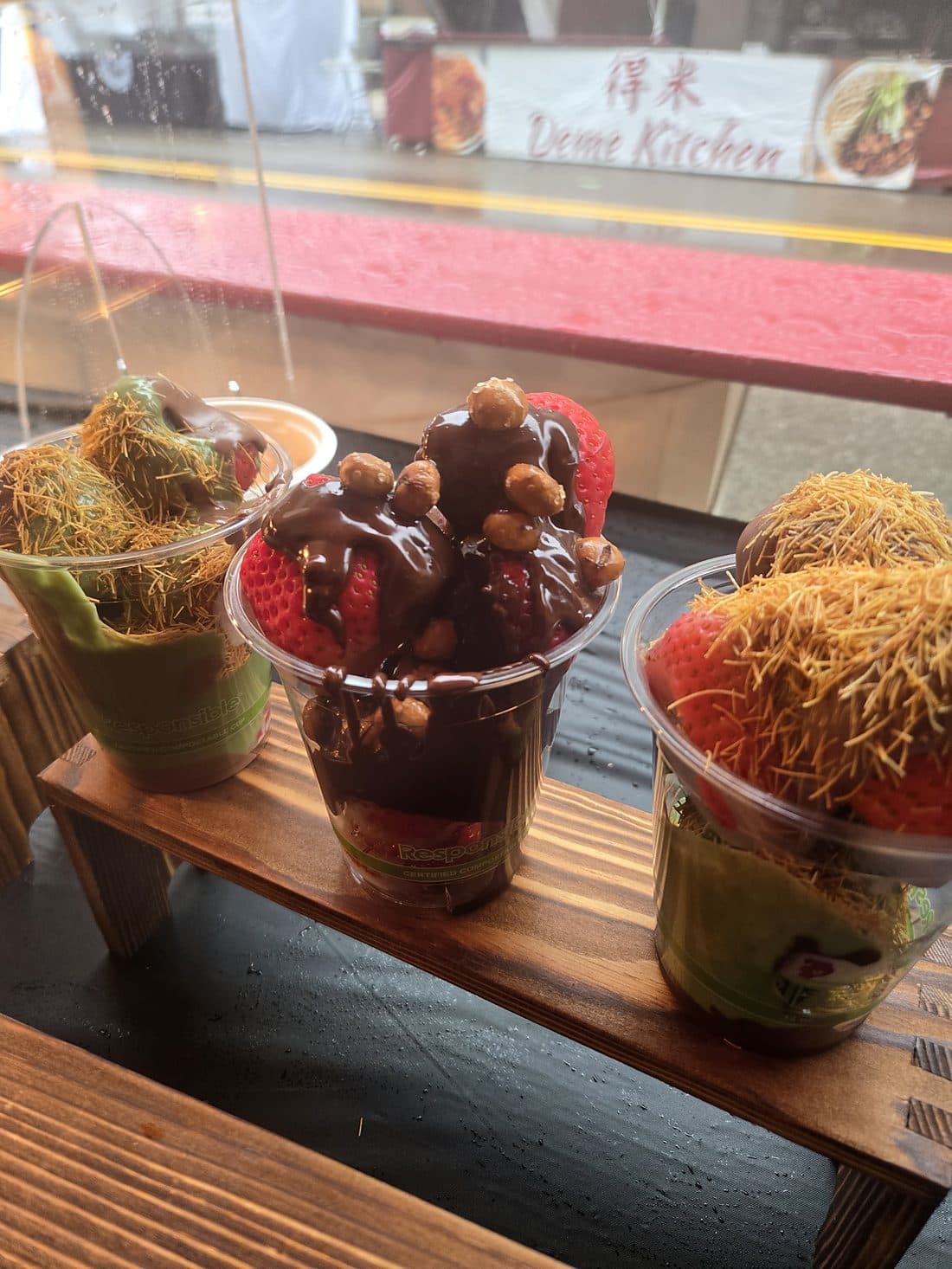 Cups of Pankis chocolate-covered strawberries with pistachio cream and toasted kanafe